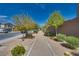 A sidewalk lined with trees, bushes, and benches in a lovely neighborhood at 4448 Mahogany Hills Ave, Las Vegas, NV 89141