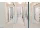 Bright bathroom hallway with multiple mirrored doors and tile floors at 4970 Black Bear Rd # 101, Las Vegas, NV 89149