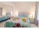 Cozy bedroom with a bed with bright quilt, two bedside tables and mirror closet door at 4970 Black Bear Rd # 101, Las Vegas, NV 89149