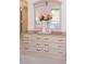 Bedroom dresser with a flower arrangement and a decorative mirror at 4970 Black Bear Rd # 101, Las Vegas, NV 89149
