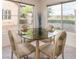 Bright dining area with large windows showcasing a serene view of the green outdoors at 4970 Black Bear Rd # 101, Las Vegas, NV 89149