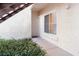 Welcoming entrance with security gate, complemented by lush landscaping and an adjacent window at 4970 Black Bear Rd # 101, Las Vegas, NV 89149