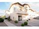 Charming townhome showcasing a two-car garage, neutral stucco, and tiled roof detail at 4970 Black Bear Rd # 101, Las Vegas, NV 89149