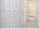 Bright hallway featuring tile floors and white doors leading to a bathroom at 4970 Black Bear Rd # 101, Las Vegas, NV 89149