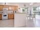Well-lit kitchen featuring white appliances, a breakfast bar, and an adjacent dining area with views at 4970 Black Bear Rd # 101, Las Vegas, NV 89149