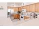 Cozy kitchen with wood cabinetry, white countertops, and stainless steel refrigerator at 4970 Black Bear Rd # 101, Las Vegas, NV 89149