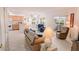 Bright living room featuring an open floor plan with a dining area and sliding door access to the balcony at 4970 Black Bear Rd # 101, Las Vegas, NV 89149