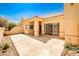 A private backyard patio featuring tan colored stucco walls and a concrete patio at 5316 Fieldstone Rd, Las Vegas, NV 89107