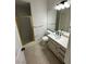 Clean bathroom with a gold-framed shower, toilet, and vanity with a white countertop at 5316 Fieldstone Rd, Las Vegas, NV 89107