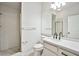Bright bathroom with modern vanity, faucet, shower with glass doors and modern lighting fixtures at 5316 Fieldstone Rd, Las Vegas, NV 89107