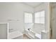 Bright bathroom with a tile surround tub under two windows and next to a shower with gold trim at 5316 Fieldstone Rd, Las Vegas, NV 89107