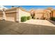 View of a home's two-car garage and entrance with an arch at 5316 Fieldstone Rd, Las Vegas, NV 89107