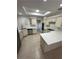 Spacious kitchen with an island, skylight, stainless steel appliances, and white cabinets at 5316 Fieldstone Rd, Las Vegas, NV 89107