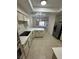 Bright kitchen with white cabinets, countertops and tile flooring, stainless steel appliances, and an open layout at 5316 Fieldstone Rd, Las Vegas, NV 89107