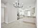 Modern kitchen with bright cabinets, updated appliances, and granite countertops with a view into the dining area at 5316 Fieldstone Rd, Las Vegas, NV 89107