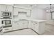 Bright kitchen features white cabinets, modern appliances, and quartz countertops at 5316 Fieldstone Rd, Las Vegas, NV 89107