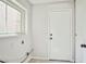 Bright laundry room with light paint, tile floor and window offering plenty of natural light at 5316 Fieldstone Rd, Las Vegas, NV 89107