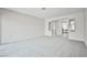 Large living room featuring soft carpet, views to the kitchen, and neutral wall color at 5316 Fieldstone Rd, Las Vegas, NV 89107