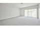 Spacious living room with soft carpet and sliding glass doors to backyard at 5316 Fieldstone Rd, Las Vegas, NV 89107