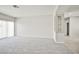 Bright living room featuring neutral paint, carpet, and natural light from the sliding glass doors to the patio at 5316 Fieldstone Rd, Las Vegas, NV 89107