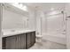 This bathroom features a shower over tub, vanity with dark cabinets, and tile floors at 538 Ylang Pl, Henderson, NV 89015