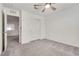 This bedroom features neutral carpet, closet, ceiling fan and white walls at 538 Ylang Pl, Henderson, NV 89015