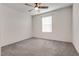 This bedroom features neutral carpet, white walls, ceiling fan and a large window at 538 Ylang Pl, Henderson, NV 89015