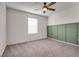 This bedroom features neutral carpet, ceiling fan, and a accent wall at 538 Ylang Pl, Henderson, NV 89015