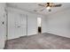 Large bedroom with neutral carpet, ceiling fan, and view to ensuite bathroom at 538 Ylang Pl, Henderson, NV 89015