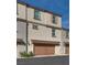 Three-story townhome with two car garage, neutral stucco, roof and doors at 538 Ylang Pl, Henderson, NV 89015