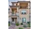 Three-story townhome with private balconies, desert landscaping, and shaded entry at 538 Ylang Pl, Henderson, NV 89015
