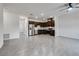 Open-concept kitchen with stainless steel appliances, dark wood cabinets, and tile flooring at 538 Ylang Pl, Henderson, NV 89015