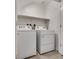 Well-lit laundry area featuring a white washer and dryer set and an above shelf at 538 Ylang Pl, Henderson, NV 89015