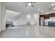 Spacious open-concept living area with tile flooring, stairs, and a view of the kitchen at 538 Ylang Pl, Henderson, NV 89015