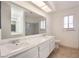 This bathroom has a marble countertop with double sinks and a large mirror at 5516 Cory Pl, Las Vegas, NV 89107