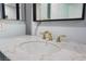 Close-up of bathroom vanity featuring marble countertop and gold-toned faucet at 5516 Cory Pl, Las Vegas, NV 89107