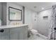 Modern bathroom featuring marble countertops, framed mirror and glass-door shower at 5516 Cory Pl, Las Vegas, NV 89107