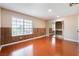 Bedroom featuring hardwood floors, wainscotting and large window at 5516 Cory Pl, Las Vegas, NV 89107