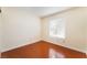 This is a bright bedroom with wood floors and a window at 5516 Cory Pl, Las Vegas, NV 89107