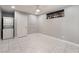 A well-lit bedroom showcasing a stacked washer/dryer unit and tile flooring at 5516 Cory Pl, Las Vegas, NV 89107