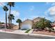 Charming two-story home featuring a two-car garage and mature palm trees at 5516 Cory Pl, Las Vegas, NV 89107