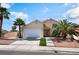 Inviting two-story home with a two-car garage, palm trees, and xeriscaping at 5516 Cory Pl, Las Vegas, NV 89107