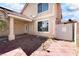 Beige two-story home with a red tile roof, desert landscaping, and covered entry at 5516 Cory Pl, Las Vegas, NV 89107