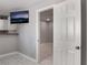 Hallway with tile floors leading to another room, TV is mounted on the wall at 5516 Cory Pl, Las Vegas, NV 89107