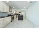 Spacious kitchen with white cabinets, stainless steel appliances, and a dark island at 5516 Cory Pl, Las Vegas, NV 89107