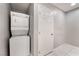 A compact laundry area with stacked washer and dryer, offering convenience and space-saving design at 5516 Cory Pl, Las Vegas, NV 89107