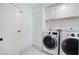 Laundry room featuring front-load washer and dryer and storage cabinets at 5516 Cory Pl, Las Vegas, NV 89107