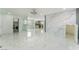 Spacious living area with marble floors, open layout, and access to laundry and kitchen at 5516 Cory Pl, Las Vegas, NV 89107