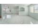Bright and open living space with access to the front entrance and an adjacent kitchen at 5516 Cory Pl, Las Vegas, NV 89107