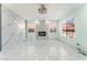 Bright living room featuring marble floors, a modern fireplace, and large windows at 5516 Cory Pl, Las Vegas, NV 89107